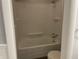 This renovated bathroom includes a large tub with shower, toilet, and built in storage at 3720 E Southern Ave, Indianapolis, IN 46203