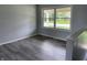 This bedroom features durable wood-look floors and a bright window offering plenty of natural light at 3720 E Southern Ave, Indianapolis, IN 46203
