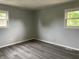 This bedroom features durable wood-look floors and bright windows offering plenty of natural light at 3720 E Southern Ave, Indianapolis, IN 46203