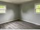 This bedroom features durable wood-look floors and bright windows offering plenty of natural light at 3720 E Southern Ave, Indianapolis, IN 46203