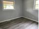 This bedroom features durable wood-look floors and bright windows offering plenty of natural light at 3720 E Southern Ave, Indianapolis, IN 46203