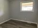 This is a bedroom with gray walls and modern flooring and a window for plenty of light at 3720 E Southern Ave, Indianapolis, IN 46203