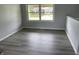 This bedroom features durable wood-look floors and a bright window offering plenty of natural light at 3720 E Southern Ave, Indianapolis, IN 46203