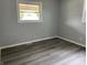 This bedroom features durable wood-look floors and bright windows offering plenty of natural light at 3720 E Southern Ave, Indianapolis, IN 46203