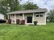 Charming two-story home with landscaped front yard, and inviting entryway with large columns at 3720 E Southern Ave, Indianapolis, IN 46203