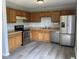The kitchen has stainless steel appliances, a double sink, and beautiful wood cabinets at 3720 E Southern Ave, Indianapolis, IN 46203