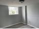 Room featuring glass block window, wainscotting, and vinyl floors at 3720 E Southern Ave, Indianapolis, IN 46203