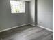 Room featuring glass block window, wainscotting, and vinyl floors at 3720 E Southern Ave, Indianapolis, IN 46203