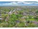 An expansive aerial view showcasing a neighborhood with mature trees, community church, and inviting residential streets at 4169 Central Ave, Indianapolis, IN 46205