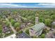 Scenic aerial view of neighborhood featuring a church and tree-lined streets, highlighting a peaceful and community-oriented environment at 4169 Central Ave, Indianapolis, IN 46205