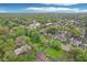 An expansive aerial view showcasing a neighborhood with mature trees, a community church, and inviting residential streets at 4169 Central Ave, Indianapolis, IN 46205