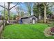 Private backyard with a play structure and cozy shed; perfect for outdoor enjoyment at 4169 Central Ave, Indianapolis, IN 46205