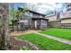 Fenced backyard with grassy area, stone pathway, and patio set for outdoor dining at 4169 Central Ave, Indianapolis, IN 46205