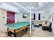 Finished basement with ping pong table, tv, sofa and accent lighting at 4169 Central Ave, Indianapolis, IN 46205