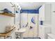Charming bathroom featuring a pedestal sink, tiled walls, and decorative shower curtain at 4169 Central Ave, Indianapolis, IN 46205