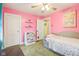 Bright bedroom featuring pink walls, pull out twin bed, two closets and three floating shelves at 4169 Central Ave, Indianapolis, IN 46205