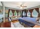 Comfortable bedroom with ample natural light, a cozy couch, and hardwood floors at 4169 Central Ave, Indianapolis, IN 46205