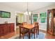 Bright dining room with wood table and chairs, plus a vintage china cabinet at 4169 Central Ave, Indianapolis, IN 46205