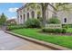 Exterior shot of St. Joan of Arc Church featuring manicured green spaces and a large stone sign at 4169 Central Ave, Indianapolis, IN 46205