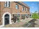 Exterior shot of a modern brick building featuring multiple store fronts, black trimmed windows, and patio seating at 4169 Central Ave, Indianapolis, IN 46205