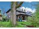 View of home with beautiful yard, lush landscaping, and a large tree, creating a serene setting at 4169 Central Ave, Indianapolis, IN 46205