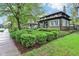 Nice house showcasing its curb appeal with manicured shrubs and a well-kept lawn in a beautiful neighborhood at 4169 Central Ave, Indianapolis, IN 46205