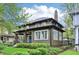 Exterior shot showcasing the architectural details and well-maintained landscaping of this lovely home at 4169 Central Ave, Indianapolis, IN 46205
