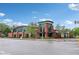 Modern brick building exterior with arched glass entryway and landscaped surroundings under a bright sky at 4169 Central Ave, Indianapolis, IN 46205