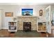 Cozy fireplace with stacked stone surround, built-in shelving, and a rustic wood-burning stove at 4169 Central Ave, Indianapolis, IN 46205
