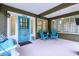 Inviting front porch with a swing, blue seating, and decorative details for a cozy outdoor space at 4169 Central Ave, Indianapolis, IN 46205
