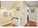 Upstairs hallway featuring hardwood floors, arched decorative shelving, and neutral paint at 4169 Central Ave, Indianapolis, IN 46205