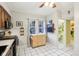 Kitchen with black appliances, and a view into the neighboring bathroom at 4169 Central Ave, Indianapolis, IN 46205