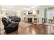 Cozy living room featuring hardwood floors, a stone fireplace, and comfortable seating at 4169 Central Ave, Indianapolis, IN 46205