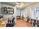 Bright home office with multiple windows and a decorative ceiling fan at 4169 Central Ave, Indianapolis, IN 46205