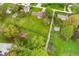 Overhead shot of a home with a large yard including gardens, a shed and surrounding greenery and neighborhood at 417 W Ash St, Jamestown, IN 46147