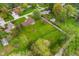 Aerial view of a home boasting a spacious green lawn, storage shed, mature trees in a suburban neighborhood at 417 W Ash St, Jamestown, IN 46147