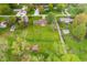 Sprawling aerial shot of a house with expansive yard, sheds, and surrounding foliage in residential neighborhood at 417 W Ash St, Jamestown, IN 46147