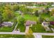 Expansive aerial view of a well-maintained home with lush green lawn, mature trees, and a long driveway at 417 W Ash St, Jamestown, IN 46147