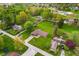 Overhead view of a suburban home featuring a large, green lawn and surrounded by mature trees in a residential area at 417 W Ash St, Jamestown, IN 46147