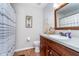 Charming bathroom with vanity, toilet, and shower with striped curtain at 417 W Ash St, Jamestown, IN 46147