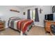 Cozy bedroom features natural light and carpeted floors with a television at 417 W Ash St, Jamestown, IN 46147