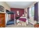 Cozy bedroom with a single bed, a large window, and a functional treadmill at 417 W Ash St, Jamestown, IN 46147