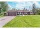 Charming brick ranch home with a well-manicured lawn and attached two-car garage at 417 W Ash St, Jamestown, IN 46147