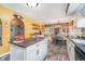Open kitchen layout with dining area, white cabinets, and views into adjacent living spaces at 417 W Ash St, Jamestown, IN 46147