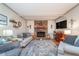 Cozy living room featuring a brick fireplace, comfortable seating, and rustic decor at 417 W Ash St, Jamestown, IN 46147