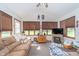Bright sunroom featuring large windows, a vaulted ceiling, and a cozy seating area with a gas fireplace at 417 W Ash St, Jamestown, IN 46147