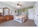 Well-lit main bedroom features neutral wall paint, a ceiling fan, carpet, and furniture at 417 W Ash St, Jamestown, IN 46147