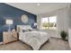 Stylishly decorated main bedroom with a blue accent wall, white bedding, and ample natural light at 4340 Pine Bluff Dr, Bargersville, IN 46106