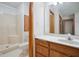 Clean bathroom with a single sink vanity, toilet, and shower-tub combo with glass doors at 4611 29Th St, Columbus, IN 47203