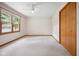 Bright and airy bedroom with carpeted floors, closet, and a ceiling fan at 4611 29Th St, Columbus, IN 47203